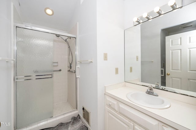 bathroom featuring visible vents, a shower stall, and vanity