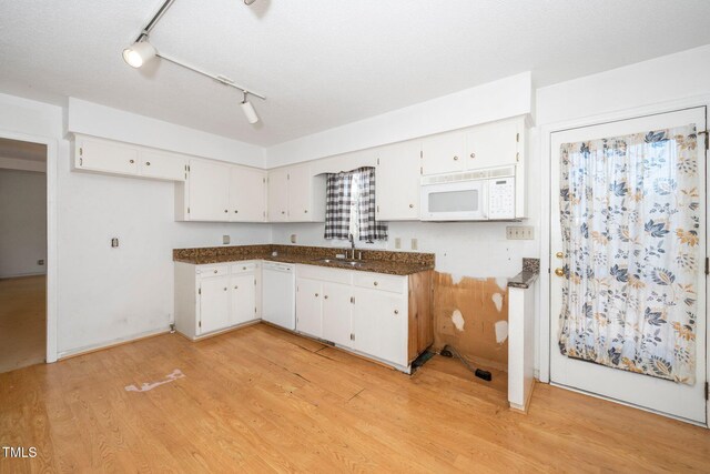 kitchen with light wood finished floors, rail lighting, white cabinetry, a sink, and white appliances