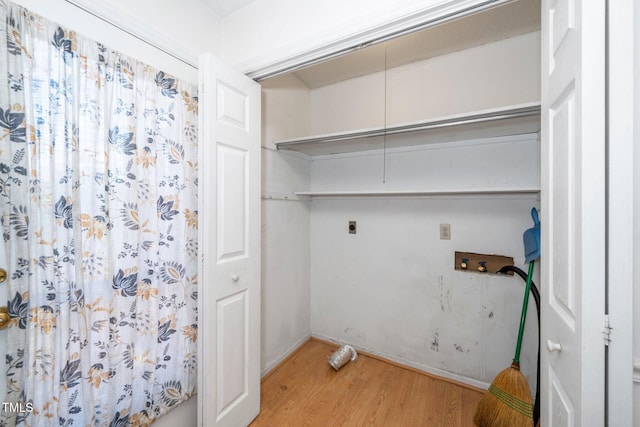 clothes washing area featuring hookup for a washing machine, attic access, electric dryer hookup, wood finished floors, and laundry area