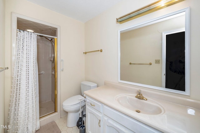 bathroom featuring a stall shower, tile patterned flooring, vanity, and toilet