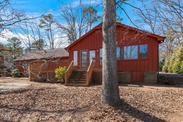 view of front of property with a deck and board and batten siding