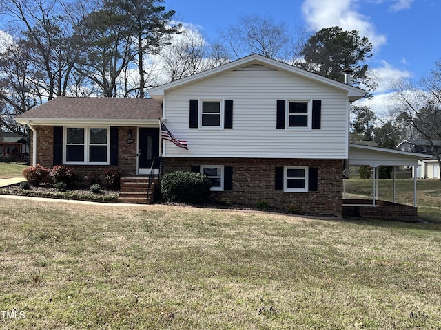 split level home featuring brick siding and a front lawn