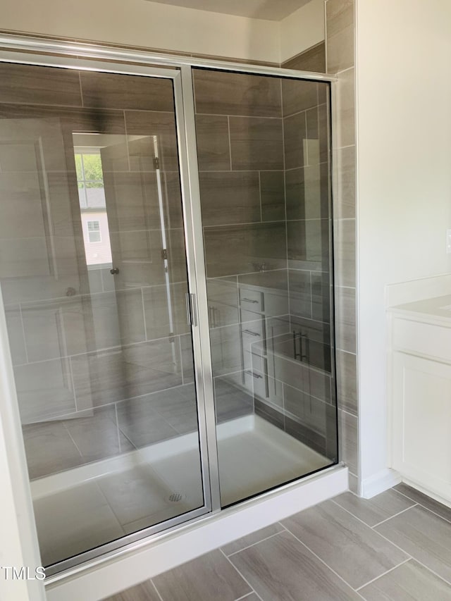 bathroom featuring a stall shower and vanity