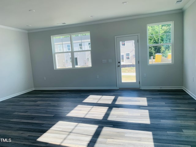 interior space featuring visible vents, baseboards, crown molding, and wood finished floors