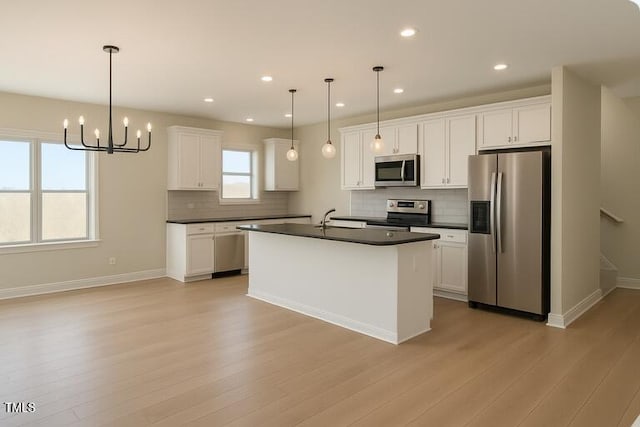148 Mohawk Dr, Louisburg, NC 27549 - kitchen featuring appliances with stainless steel finishes, dark countertops, backsplash, and recessed lighting