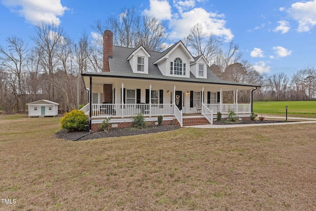 farmhouse with covered porch, a chimney, a front yard, and a shingled roof