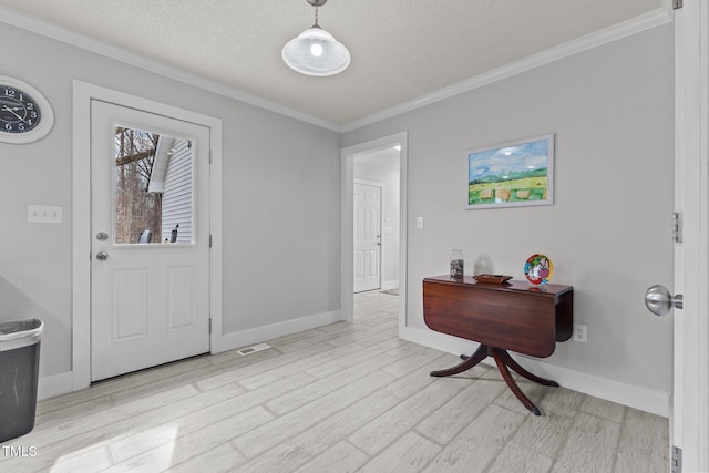 entryway with a textured ceiling, wood finished floors, and ornamental molding