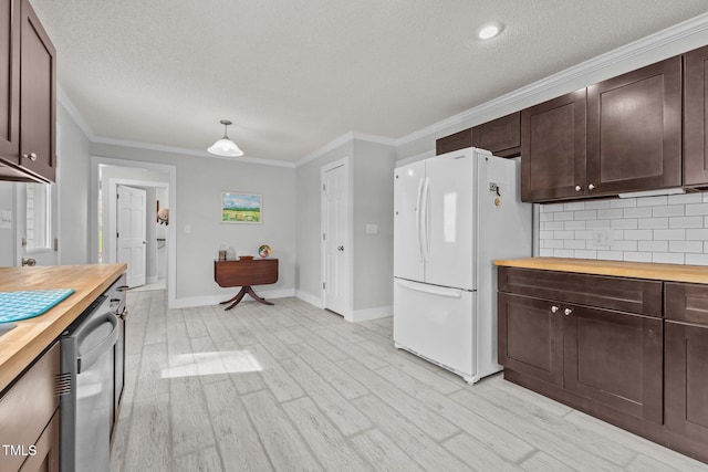 kitchen with butcher block countertops, dark brown cabinets, and freestanding refrigerator