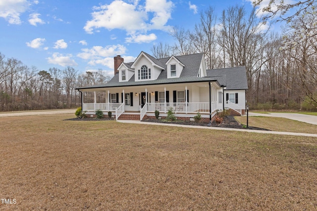 view of front of property with driveway, a porch, a front yard, a shingled roof, and a chimney