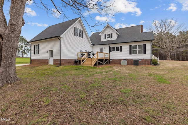 rear view of house with roof with shingles, a wooden deck, a yard, central AC, and crawl space