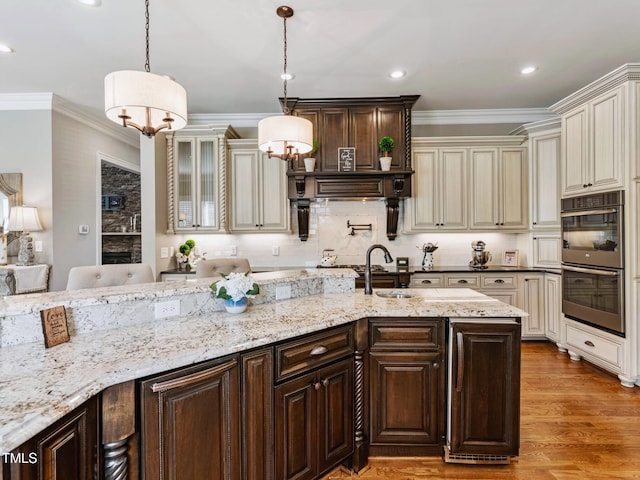 309 Shoreline Dr, Princeton, NC 27569 - kitchen featuring stainless steel double oven, dark brown cabinetry, cream cabinetry, and ornamental molding