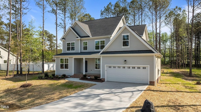 25 Arbor Dr, Youngsville, NC 27596 - view of front facade with covered porch, a garage, fence, driveway, and roof with shingles