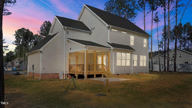25 Arbor Dr, Youngsville, NC 27596 - back of house at dusk with crawl space and a lawn