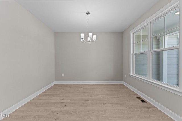 25 Arbor Dr, Youngsville, NC 27596 - spare room featuring a chandelier, visible vents, light wood-type flooring, and baseboards