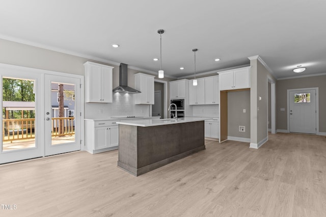 25 Arbor Dr, Youngsville, NC 27596 - kitchen featuring ornamental molding, wall chimney range hood, light countertops, decorative backsplash, and a sink