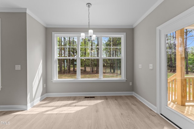 25 Arbor Dr, Youngsville, NC 27596 - unfurnished dining area featuring ornamental molding, visible vents, light wood finished floors, baseboards, and a notable chandelier