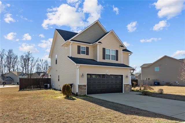 craftsman-style home with central AC unit, a garage, fence, stone siding, and concrete driveway