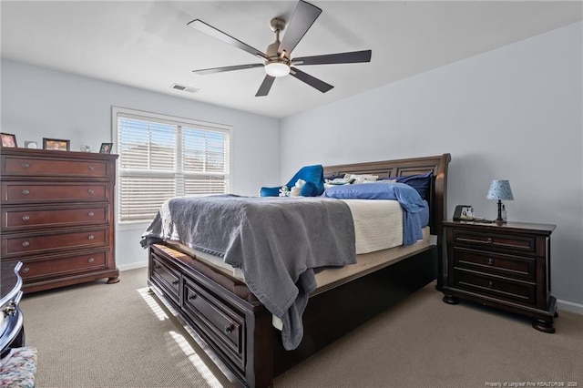 bedroom featuring a ceiling fan, light colored carpet, visible vents, and baseboards