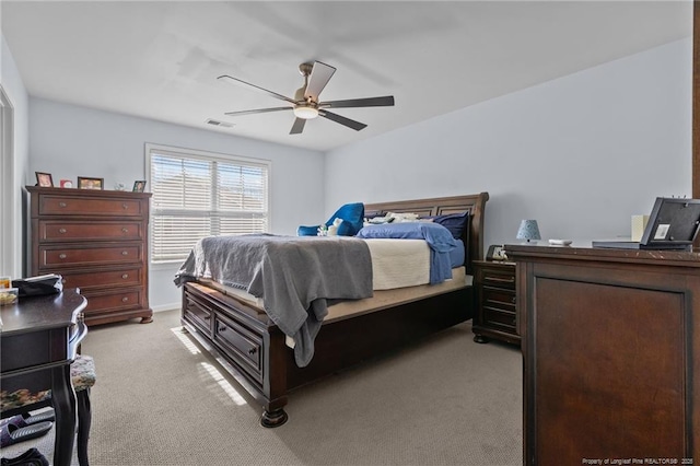 bedroom with light carpet, ceiling fan, and visible vents