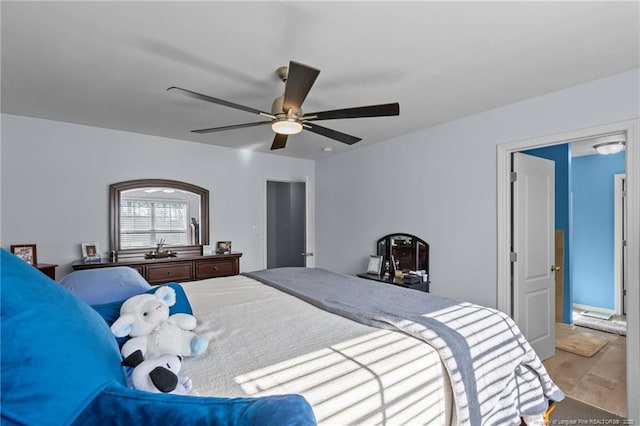 bedroom featuring wood finished floors and a ceiling fan