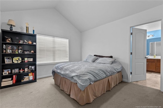 bedroom featuring lofted ceiling, light colored carpet, and baseboards