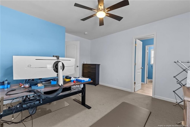 carpeted office featuring baseboards, vaulted ceiling, and a ceiling fan