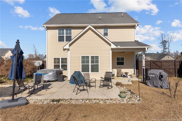 rear view of house with a gate, fence, and a patio