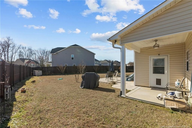 view of yard featuring a patio area, ceiling fan, and a fenced backyard