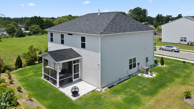 back of property with a sunroom, central AC, a lawn, and roof with shingles