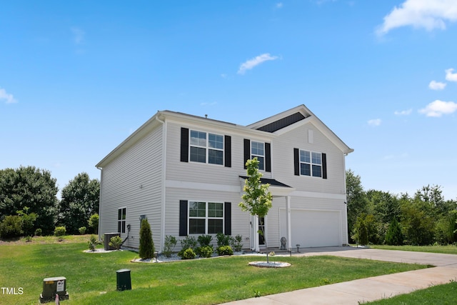 traditional-style house with an attached garage, concrete driveway, and a front yard