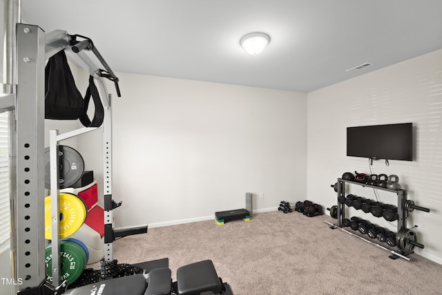 exercise area featuring carpet floors, baseboards, and visible vents