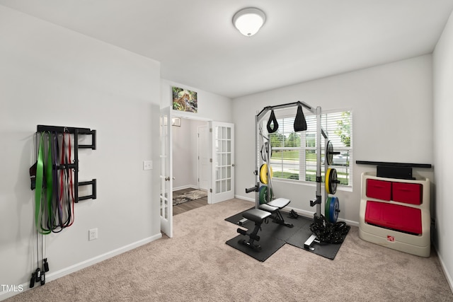 workout area with carpet floors, baseboards, and french doors