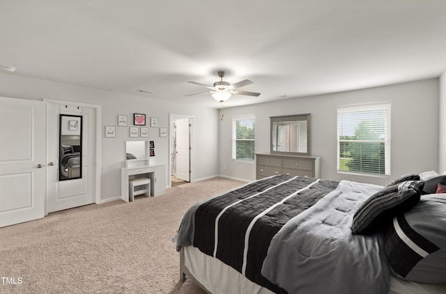 carpeted bedroom with visible vents, a ceiling fan, and baseboards