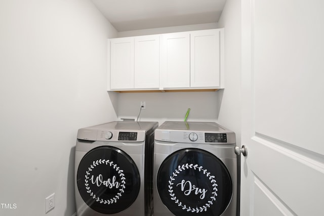 laundry area featuring washing machine and dryer and cabinet space