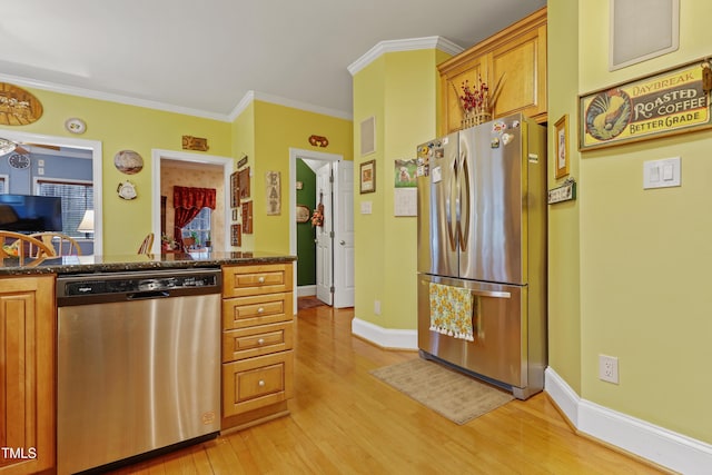 kitchen with brown cabinets, light wood-style flooring, stainless steel appliances, crown molding, and baseboards