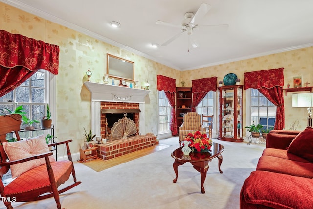 carpeted living area with ceiling fan, ornamental molding, a fireplace, and wallpapered walls