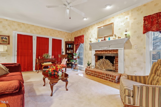 living room featuring wallpapered walls, crown molding, carpet flooring, and a ceiling fan