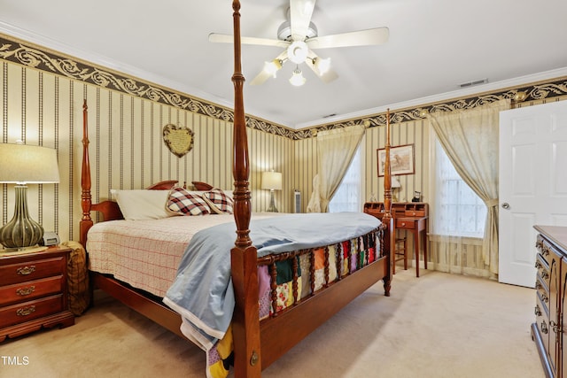 bedroom with visible vents, wallpapered walls, crown molding, ceiling fan, and light carpet