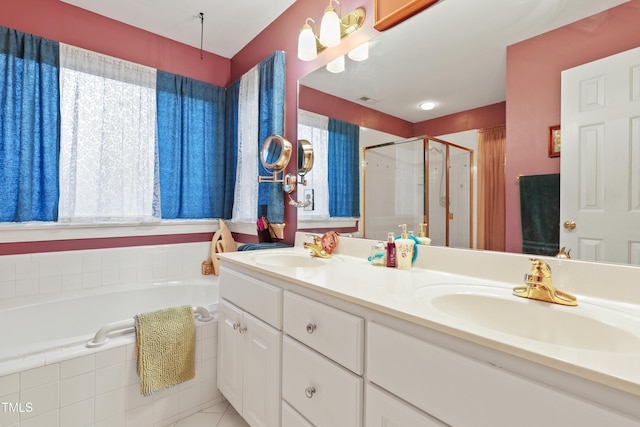 bathroom featuring a sink, a garden tub, a stall shower, and double vanity