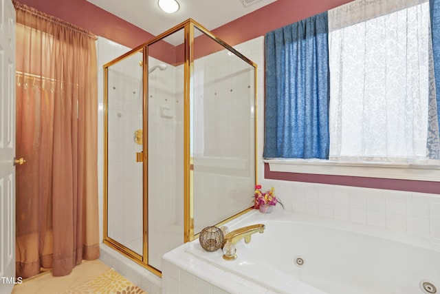 bathroom featuring tile patterned floors, a stall shower, and a whirlpool tub