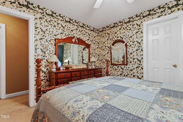 carpeted bedroom featuring wallpapered walls, a ceiling fan, and baseboards