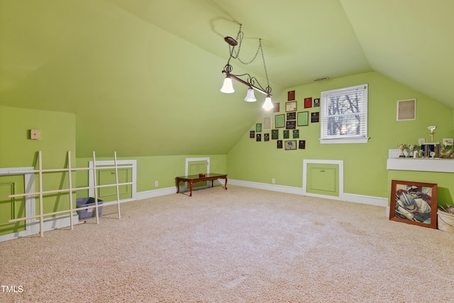 additional living space with baseboards, lofted ceiling, carpet, and visible vents