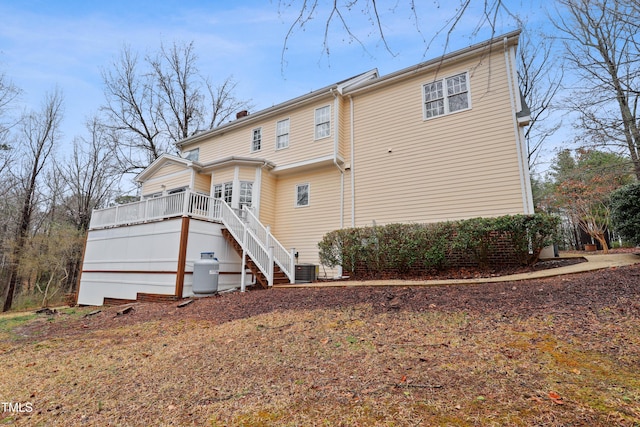 rear view of house featuring stairway and a wooden deck