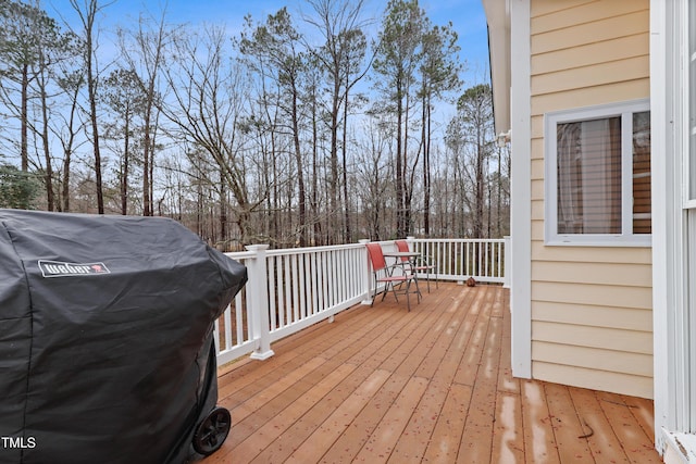 wooden deck featuring a grill