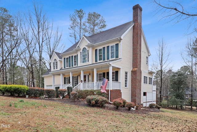 view of front of home featuring a porch and a chimney