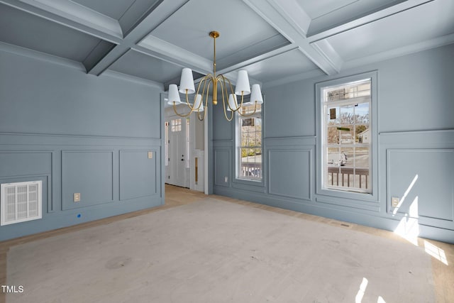 unfurnished dining area with beam ceiling, a chandelier, light wood-style flooring, and coffered ceiling