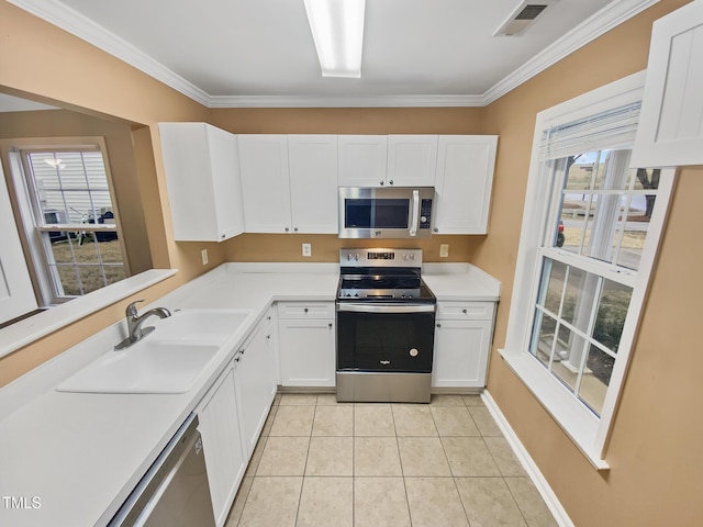 117 Woodson Dr, Clayton, NC 27527 - kitchen with stainless steel appliances, visible vents, light tile patterned flooring, a sink, and white cabinetry