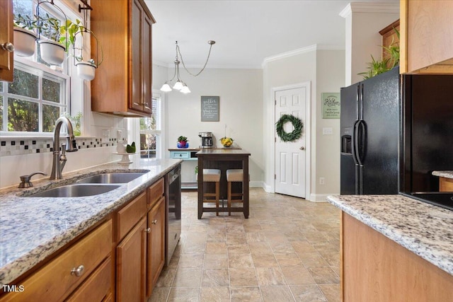 kitchen featuring a sink, stainless steel dishwasher, black refrigerator with ice dispenser, brown cabinetry, and tasteful backsplash