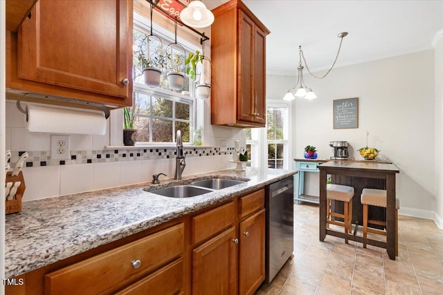 kitchen with dishwasher, decorative backsplash, brown cabinetry, and a sink