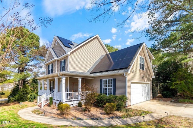 view of home's exterior with a porch, driveway, an attached garage, and solar panels